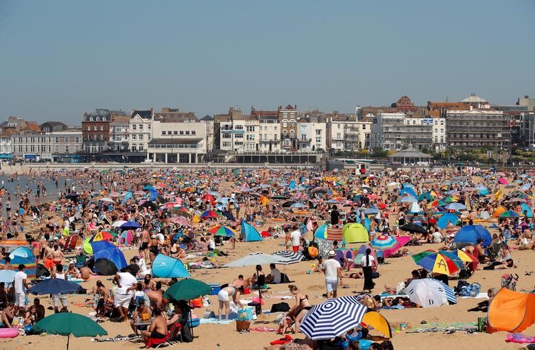People enjoy the hot weather on Margate beach in Margate, Britain. REUTERS/Andrew Couldridge    